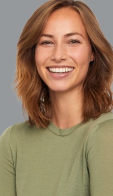 Woman in dark green blouse grinning