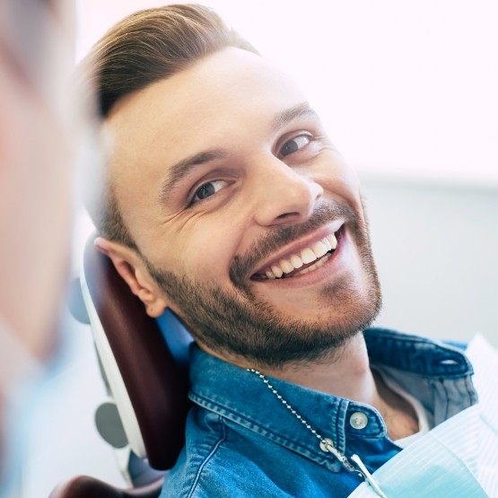 Smiling man leaning back in dental chair