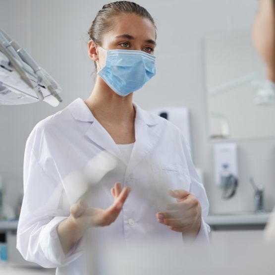 Dental team member explaining something to a patient
