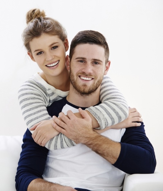 Young man and woman hugging and smiling after cosmetic dentistry in Chicago