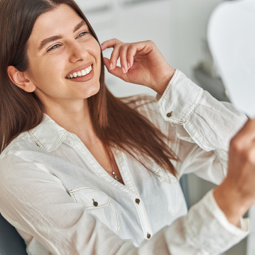 Close-up of woman in button-up shirt smiling