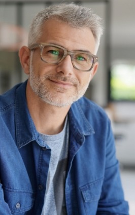 Smiling man in blue button up shirt