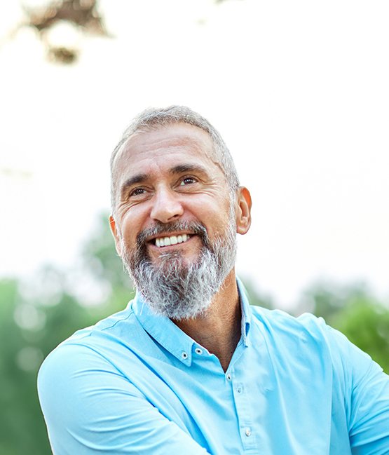 Senior man in blue shirt smiling