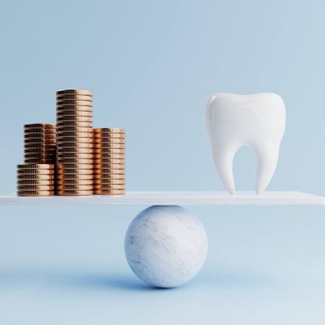 Tooth balanced against stacks of coins