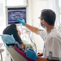 Dentist showing a patient X rays of their teeth