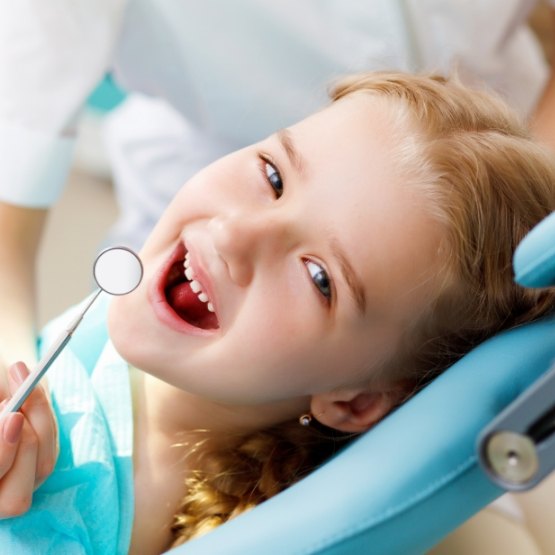 Young girl smiling in dental chair