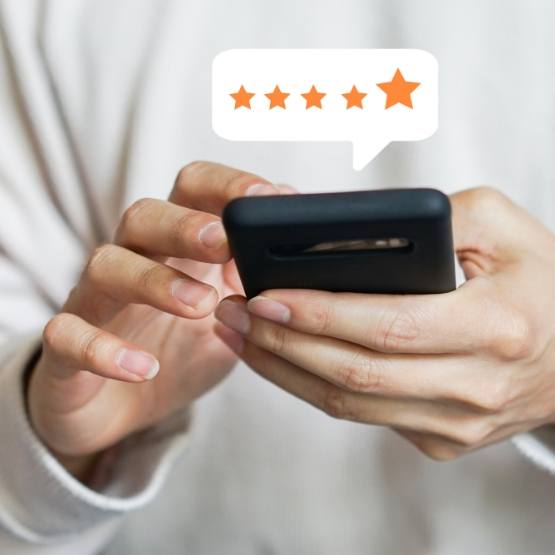 Person leaving a five star review on their phone