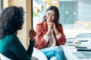 Two women having conversation in office setting