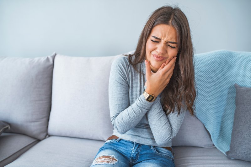 A young woman experiencing a severe toothache