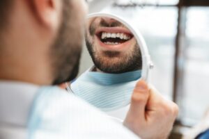 Man smiling after fixing up his gray teeth